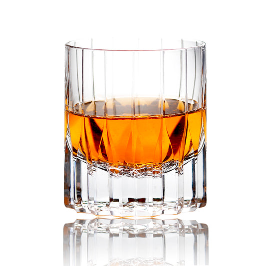 Vertical fluted hand‑cut tumbler filled with whiskey, premium home‑bar cocktail glass